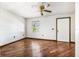 Clean living room featuring hardwood floors, a ceiling fan, and a large window for natural light at 34651 Appaloosa Trl, Zephyrhills, FL 33541