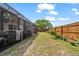 Backyard featuring a patio, landscaping, a privacy fence, and a large tree at 4209 Stratfield Dr, New Port Richey, FL 34652