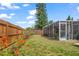Backyard featuring a patio, landscaping, a privacy fence, and a large tree at 4209 Stratfield Dr, New Port Richey, FL 34652