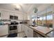 Well-lit kitchen with stainless steel appliances, granite countertops, and a view of the backyard at 4209 Stratfield Dr, New Port Richey, FL 34652