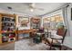 Cozy living room featuring a comfortable chair, desk and bookshelves at 4209 Stratfield Dr, New Port Richey, FL 34652