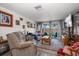 Cozy living room with comfortable seating, a television, and sliding doors to the outside at 4209 Stratfield Dr, New Port Richey, FL 34652
