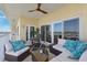 Comfortable balcony seating with plush cushions, glass table and waterfront views beyond the glass entry doors at 425 150Th Ave # 2501, Madeira Beach, FL 33708