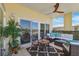 Spacious balcony with comfortable seating, tile flooring, and a ceiling fan with a glass door entry at 425 150Th Ave # 2501, Madeira Beach, FL 33708