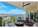 Relax on this beautiful balcony with water views, ceiling fan, and stylish outdoor furniture for ultimate comfort at 425 150Th Ave # 2501, Madeira Beach, FL 33708