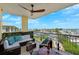 Relaxing balcony features comfortable seating and stunning waterfront views with a wooden fan overhead at 425 150Th Ave # 2501, Madeira Beach, FL 33708