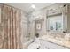 The bathroom has a large vanity, shower and tub combination and a large mirror at 425 150Th Ave # 2501, Madeira Beach, FL 33708