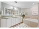 Beautiful bathroom features a tiled floor, soaking tub, and double vanity with granite countertops at 425 150Th Ave # 2501, Madeira Beach, FL 33708