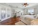 Bedroom boasts gleaming hardwood floors, a cozy rug, a ceiling fan, and natural light at 425 150Th Ave # 2501, Madeira Beach, FL 33708