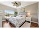 This bedroom features a large window with bench, a ceiling fan, and a plush rug at 425 150Th Ave # 2501, Madeira Beach, FL 33708