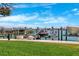 Community boat dock featuring multiple boat and jet ski lifts, lush landscaping, and waterfront views at 425 150Th Ave # 2501, Madeira Beach, FL 33708