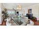 An open dining and living room area with hardwood floors, natural light and a view of the outdoor seating area at 425 150Th Ave # 2501, Madeira Beach, FL 33708