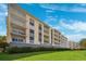 Beautiful condo building featuring balconies and lush green lawns for a serene living experience at 425 150Th Ave # 2501, Madeira Beach, FL 33708