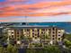 Stunning waterfront condo building featuring spacious balconies and picturesque water views at sunset at 425 150Th Ave # 2501, Madeira Beach, FL 33708