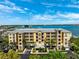 Beautiful exterior shot of the condo complex with lush landscaping, stunning views, and convenient parking at 425 150Th Ave # 2501, Madeira Beach, FL 33708