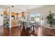 A dining area adjacent to a spacious kitchen features granite counters, stainless steel appliances and wood cabinets at 425 150Th Ave # 2501, Madeira Beach, FL 33708