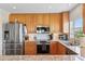 Modern kitchen with stainless steel appliances, and wood cabinets at 425 150Th Ave # 2501, Madeira Beach, FL 33708