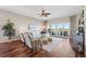 Cozy living room with a ceiling fan, hardwood flooring, comfortable seating, and access to a balcony at 425 150Th Ave # 2501, Madeira Beach, FL 33708