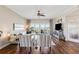 A well-lit living room with hardwood floors and a sliding glass door to a patio overlooking the water at 425 150Th Ave # 2501, Madeira Beach, FL 33708