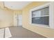 Tiled patio area with a window, front door, and textured exterior walls at 425 150Th Ave # 2501, Madeira Beach, FL 33708