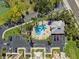 An overhead view of the community pool, surrounded by seating and tropical landscaping at 425 150Th Ave # 2501, Madeira Beach, FL 33708