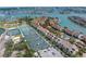 Beautiful aerial view of a waterfront condo with tennis courts and lush landscaping at 472 Sandy Hook Rd, Treasure Island, FL 33706