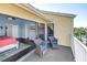 View from a balcony with sitting area looking into a bright bedroom at 472 Sandy Hook Rd, Treasure Island, FL 33706