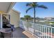 Outdoor balcony area with seating overlooking tennis courts and a calm body of water at 472 Sandy Hook Rd, Treasure Island, FL 33706