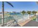 Balcony view overlooking tennis courts and water in a sunny outdoor setting at 472 Sandy Hook Rd, Treasure Island, FL 33706