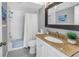 Bathroom featuring granite countertops, white cabinets, shower with bathtub, and ample lighting at 472 Sandy Hook Rd, Treasure Island, FL 33706