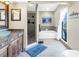 Full bathroom showing glass bowl sink, walk in shower, soaking tub, and tile floors at 472 Sandy Hook Rd, Treasure Island, FL 33706