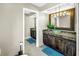 Dual sink bathroom with dark cabinets, modern lights, and tile floors at 472 Sandy Hook Rd, Treasure Island, FL 33706