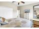 Bright bedroom with a patterned bedspread, white dresser, and hardwood floors at 472 Sandy Hook Rd, Treasure Island, FL 33706
