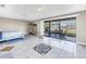 Large bedroom with tiled floors and a sliding door to an outdoor area with seating at 472 Sandy Hook Rd, Treasure Island, FL 33706