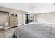 Bright bedroom with neutral tones, tiled flooring, and a sliding door to the patio at 472 Sandy Hook Rd, Treasure Island, FL 33706