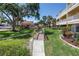 Lush community grounds showcasing a picturesque bridge and walkway leading to the outdoor kitchen at 472 Sandy Hook Rd, Treasure Island, FL 33706