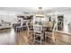 Open-concept dining area and kitchen featuring a dining table, chairs, and kitchen island with bar stools at 472 Sandy Hook Rd, Treasure Island, FL 33706