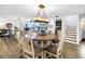 Open-concept dining area with a round table, six chairs, a chandelier, and views of the living space at 472 Sandy Hook Rd, Treasure Island, FL 33706