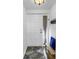 Cozy entryway featuring a decorative rug, bench, and white door at 472 Sandy Hook Rd, Treasure Island, FL 33706