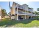 Back exterior of condo featuring multiple levels and balconies with outdoor seating at 472 Sandy Hook Rd, Treasure Island, FL 33706