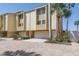 Spacious multi-level townhouse featuring a two-car garage and private entrance at 472 Sandy Hook Rd, Treasure Island, FL 33706