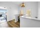 Bright hallway featuring wood floors, white walls, and an open view to a bedroom and water views at 472 Sandy Hook Rd, Treasure Island, FL 33706