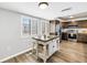 Bright kitchen featuring an island, stainless steel appliances, and wood floors at 472 Sandy Hook Rd, Treasure Island, FL 33706