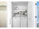 Laundry room area featuring a washer and dryer with built-in shelving at 472 Sandy Hook Rd, Treasure Island, FL 33706