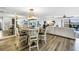 Spacious open-concept living and dining area with water views, modern furniture, and stylish decor at 472 Sandy Hook Rd, Treasure Island, FL 33706
