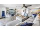 Bright living room with cozy seating and view of the dining area and outdoor scenery at 472 Sandy Hook Rd, Treasure Island, FL 33706