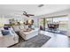 Comfortable living room with access to a balcony offering serene water views at 472 Sandy Hook Rd, Treasure Island, FL 33706
