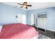 Bright bedroom with walk-in closet, chest of drawers with TV and dark hard wood floors at 472 Sandy Hook Rd, Treasure Island, FL 33706