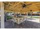 Inviting outdoor kitchen featuring a bar, seating, and fans, perfect for community gatherings at 472 Sandy Hook Rd, Treasure Island, FL 33706