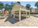 Charming outdoor kitchen area with a bar and seating, enhancing the outdoor living experience at 472 Sandy Hook Rd, Treasure Island, FL 33706